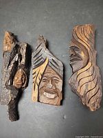 All three wood face carvings front view