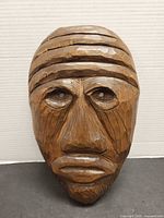 Front view of entire carved wooden mask