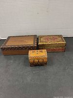 Three wood boxes together showing size difference and decoration
