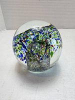Overall view of glass paperweight showing millefiori design