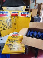 Four yellow Pepsi menu boards and box of blue letters