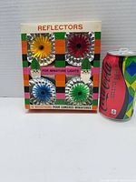 Front of box showing multiple colored reflectors and branding