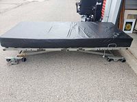 side view of assembled adjustable bed with mattress