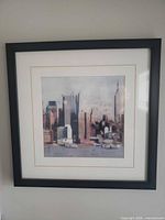Full view of framed cityscape print on wall