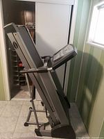 Treadmill folded upright showing full frame and fold mechanism