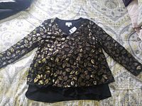 Full view of blouse laid flat showing pattern and long sleeves