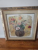 Full view of framed floral print standing on floor