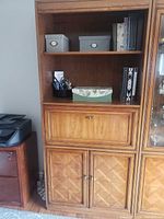 Front view of full-height wood veneer bookcase showing open shelves, drop-front compartment, and lower cabinets