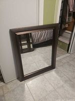 Front view of rectangular mirror leaning against wall