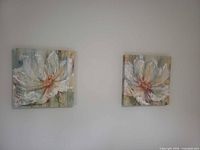 Both square floral canvases on wall