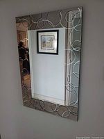 Full view of wall mirror hung on wall