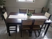 Full set showing table and six chairs in dining area