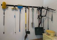 Overall view of wall-mounted rack with all hanging tools