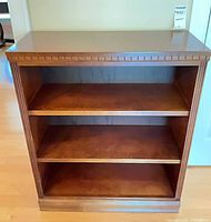 Front view of bookcase showing three fixed shelves and overall finish