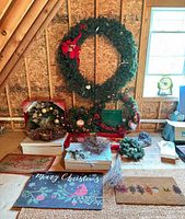 Overall lot showing large wreath, small wreaths/garlands, ornaments box, bird nest, door mats and tote