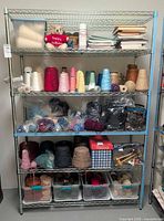Full view of chrome wire shelving unit loaded with yarn and other personal items