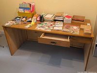 Front view of desk showing top surface, open centre drawer and overall structure