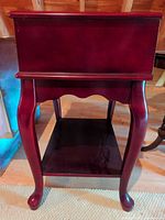 Front angled view showing cabriole legs and lower shelf