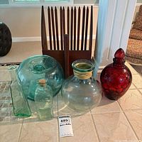 Group shot of five glass pieces and wooden blueberry picker