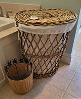 Hamper with lid in place and wastebasket beside it