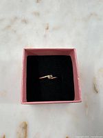 Ring top view in box showing diamond and design