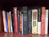 Shelf view showing multiple fiction books including Roots, Bridget Jones, The Emperor of Ocean Park and others