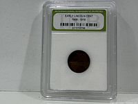 Front of INB slab showing encapsulated Lincoln Wheat Cent and label
