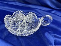 Oblique view showing handle, rim, and cut pattern