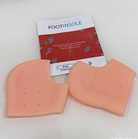 pair of peach silicone heel protectors with FootInsole insert