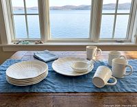 Full set on table: stack of plates, five mugs, chip & dip platter