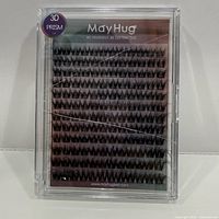 Front view of sealed MayHug lash tray showing rows of black cluster lashes and 3D Prism label.