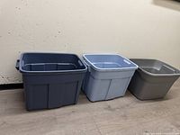 Three plastic storage totes side by side