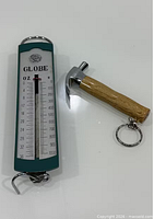 Front view of Globe hanging scale showing graduations and hammer keychain
