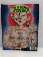 Front cover showing Alfred E. Neuman with tattoos and microphone