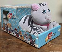 Plush tabby cat inside original box, front left perspective