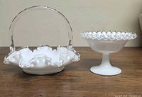 front view of both milk glass pieces showing ruffled clear edge and handle