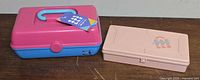 Two Caboodles cases side by side on tabletop