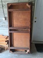 Underside of solid wood table showing frame and leg brackets