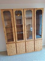 Full view of china cabinet showing four glass doors above and four wood doors below