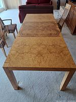Full view of rectangular bird’s-eye maple table with chairs around it