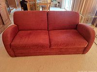 Front view of red loveseat showing overall design