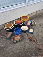 Group shot of all assorted pots against wall