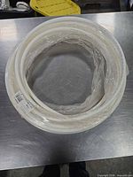 Coiled white PEX tubing wrapped in plastic