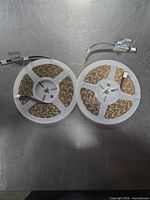 Two LED strip rolls on reels showing connectors and PCB