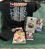 Overall lot with T-shirts, books, sealed game, photocard album