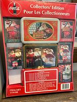 Back of sealed package showing all card deck images and tins