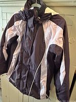 Front view of purple and light lavender Columbia hooded winter jacket on hanger