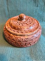 Closed round carved wooden box with lid