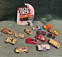 All 14 die-cast vehicles and sealed Tech Deck fingerboard displayed together