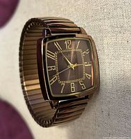 Front angled view of watch showing case, dial, and stretch bracelet